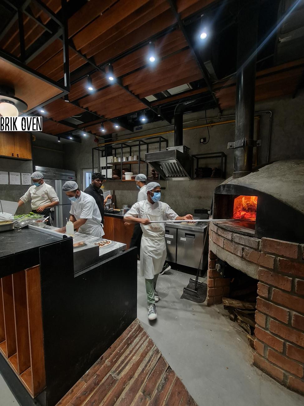 Brik Oven pizzeria kitchen with wood-fired oven